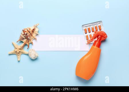 Blank sheet of paper, pills, sunscreen cream and starfishes on color ...