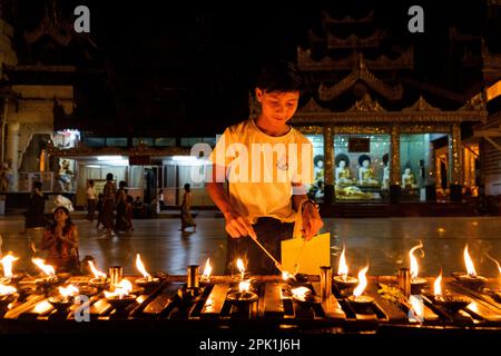 Yangon, Myanmar. 05th Apr, 2023. A boy lights incense while praying at Shwedagon Pagoda in Yangon. Daily life during the deadly civil war in Myanmar. On February 1, 2021, the military junta government (Tatmadaw) seized power by coup, jailing the democratically-elected government and plunging the country into an ongoing humanitarian crisis. Credit: Matt Hunt/Neato/Alamy Live News Stock Photo
