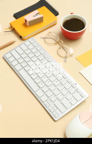 Composition with keyboard, coffee, calculator and notepad on beige background Stock Photo