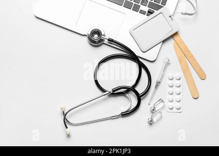 Stethoscope, laptop, badge and drugs on white background Stock Photo ...