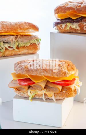 Three ciabatta sandwiches placed on wooden planks. Stock Photo