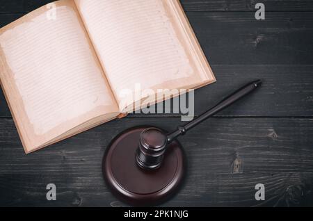 Law and Justice , Legality concept, Judge Gavel and law book on a black wooden background, law library concept. Stock Photo