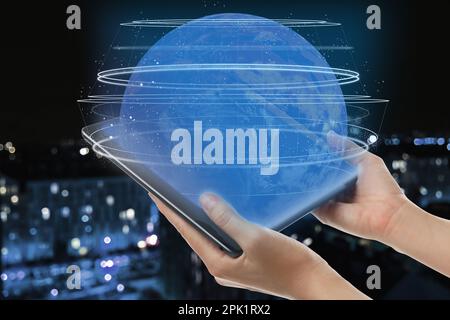 Global network. Woman holding tablet and virtual image of globe with internet connection lines Stock Photo