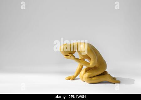Plasticine figure of crying human on white background. Space for text Stock Photo