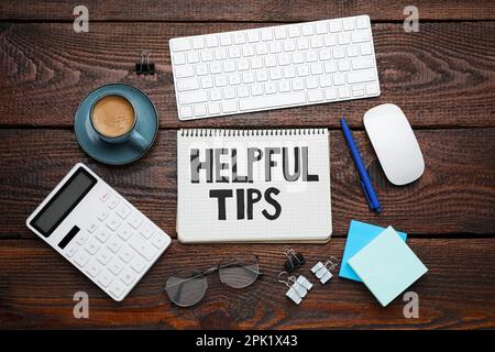 Flat lay composition with text Helpful Tips in notebook on wooden table Stock Photo