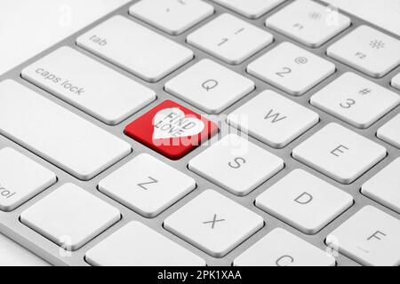 Online dating. Red button with words Find Love on computer keyboard, closeup Stock Photo