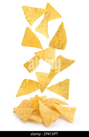Tasty tortilla chips (nachos) falling into pile on white background Stock Photo