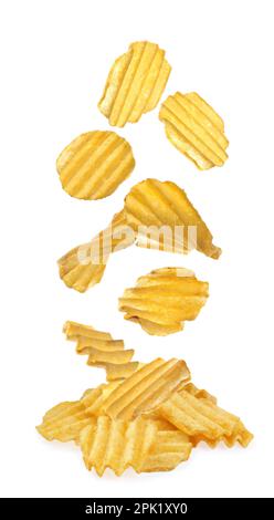 Ridged crispy potato chips falling into heap on white background Stock Photo