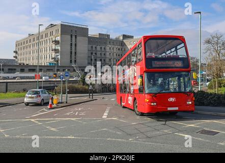 The main entrance to Derriford Hospital Plymouth. The public are encouraged to use public transport with links across the city. A bight red CityBus to Stock Photo