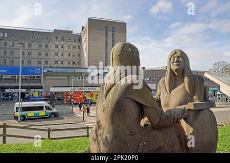 Tammy a sculpture by Allan Redford reflects on disability and caring opposite the main entrance to Derriford Hospital Plymouth Stock Photo