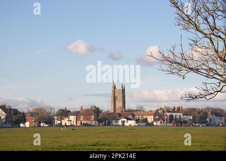 Lydd village green, known as the Rype or Ripe, with the surrounding houses and the tower of All Saints Church in the background. Stock Photo