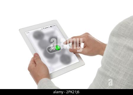 Man using tablet with switch on VPN on white, closeup Stock Photo