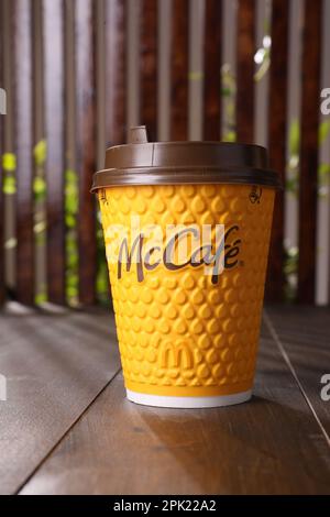 MYKOLAIV, UKRAINE - AUGUST 12, 2021: Hot McDonald's drink on wooden table Stock Photo