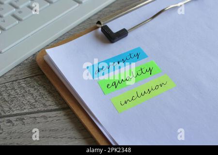 Paper clipboard with text Diversity Equality Inclusion write on a sticky note. Stock Photo