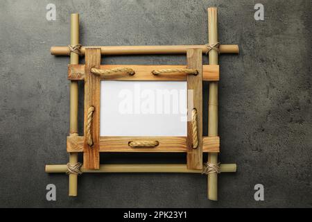 Empty bamboo frame on grey table, top view. Space for text Stock Photo ...