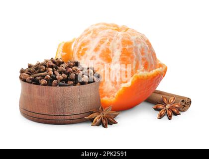 Fresh ripe tangerine, cinnamon, anises and cloves in wooden bowl on white background Stock Photo