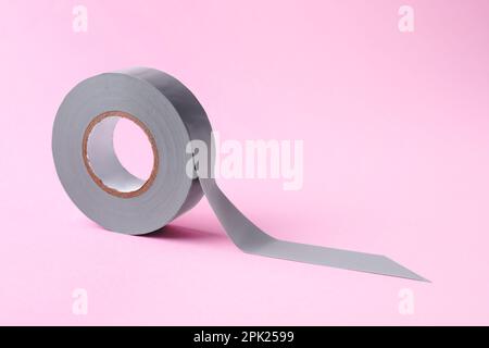 Grey insulating tape on pink background. Space for text Stock Photo