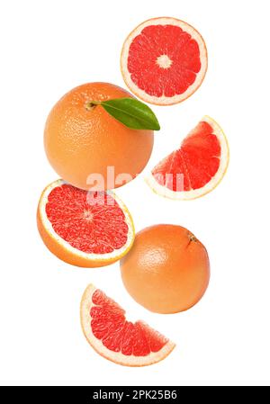 Tasty ripe grapefruits falling on white background Stock Photo