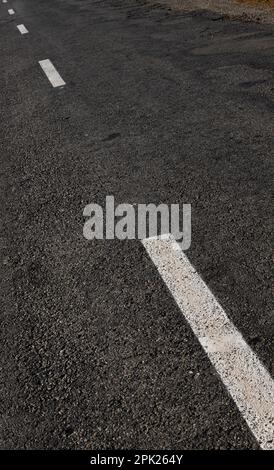 White dotted line on city asphalt road background. Stock Photo