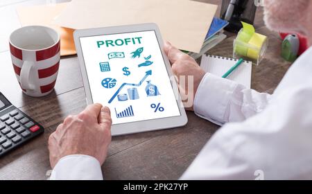 Profit concept shown on a tablet held by a man Stock Photo