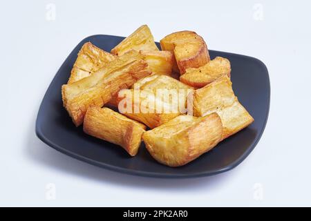Fried cassava known as 'singkong goreng', famous simple indonesian fried snack on isolated white background Stock Photo