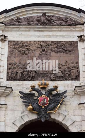 Wooden bas-relief 'The Overthrow of Simon the Magi by the Apostle Peter' and Russian  Empire coat of arms (double-headed eagle), made in a lead on the Stock Photo