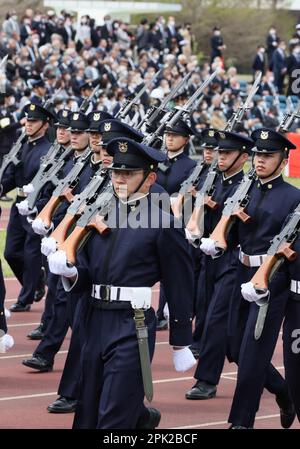 Students of the National Defense Academy parade the Japanese flag 