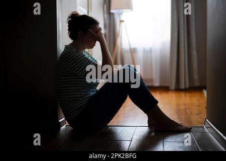 stressed woman silhouette - sitting on luggage Stock Photo - Alamy