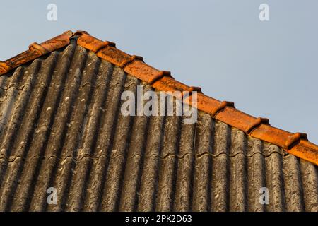 Old Asbestos Cement Slate Roofs. Asbestos Release from Asbestos-cement Slate Roofing Buildings. Stock Photo