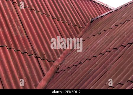 Old Asbestos Cement Slate Roofs. Asbestos Release from Asbestos-cement Slate Roofing Buildings. Stock Photo
