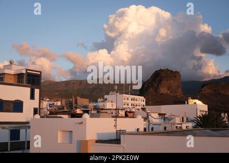 Typical old fishing village  in the evening sunlight in front of beautiful mountains, Puerto de las Nieves, Gran Canaria Stock Photo