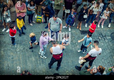 Seville, Spain; April 4, 2023: Float bearer (costalero) of the Cerro brotherhood giving holy cards to kids Stock Photo