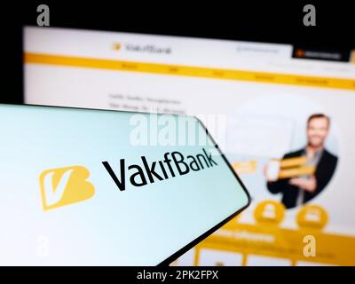 Mobile phone with logo of Turkiye Vakiflar Bankasi T.A.O. (VakifBank) on screen in front of business website. Focus on center of phone display. Stock Photo