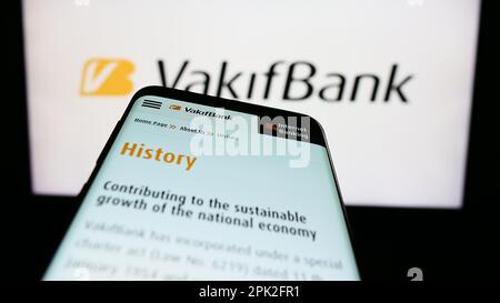 Smartphone with website of Turkiye Vakiflar Bankasi T.A.O. (VakifBank) on screen in front of business logo. Focus on top-left of phone display. Stock Photo