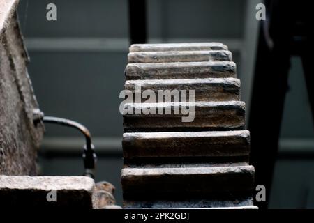 used gear wheel in dark surrounding and other mechanics Stock Photo