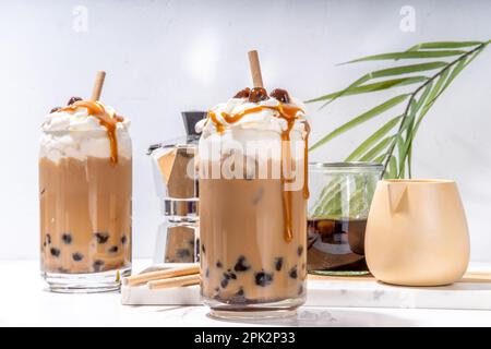 Tapioca boba balls coffee frappe, asian trendy cold coffee drink with tapioca balls and whipped coconut cream and caramel sauce Stock Photo