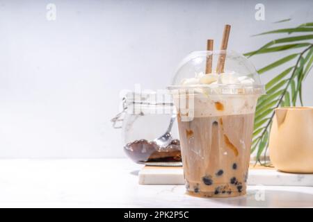 Tapioca boba balls coffee frappe, asian trendy cold coffee drink with tapioca balls and whipped coconut cream and caramel sauce Stock Photo