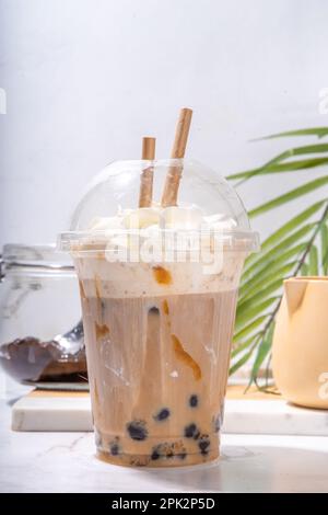 Tapioca boba balls coffee frappe, asian trendy cold coffee drink with tapioca balls and whipped coconut cream and caramel sauce Stock Photo