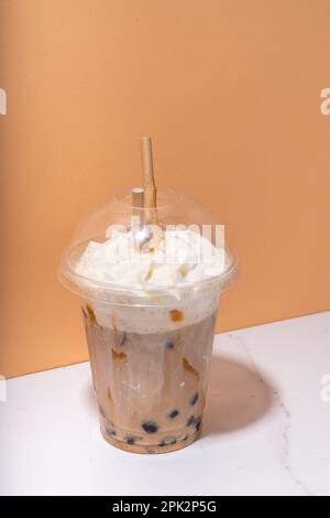 Tapioca boba balls coffee frappe, asian trendy cold coffee drink with tapioca balls and whipped coconut cream and caramel sauce Stock Photo