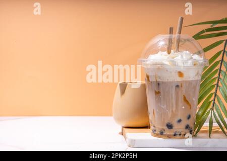 Tapioca boba balls coffee frappe, asian trendy cold coffee drink with tapioca balls and whipped coconut cream and caramel sauce Stock Photo