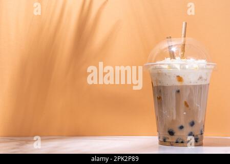 Tapioca boba balls coffee frappe, asian trendy cold coffee drink with tapioca balls and whipped coconut cream and caramel sauce Stock Photo