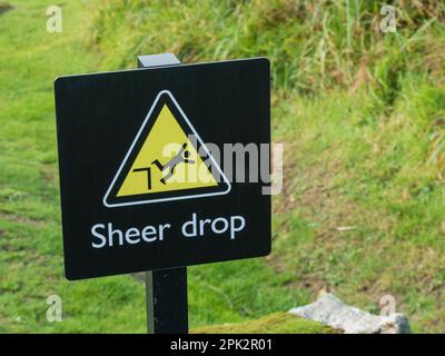 Danger drop below yellow triangle warning sign Stock Photo - Alamy