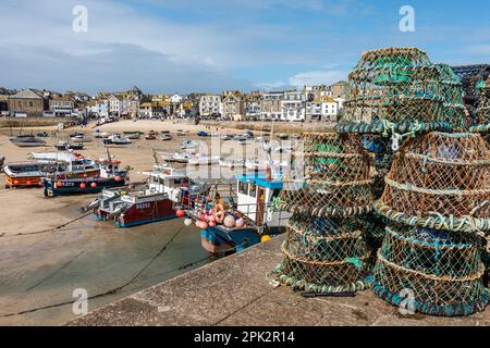 Lobster pots / creels on the quayside of St. Ives harbour at low tide in September, Cornwall, England, UK Stock Photo