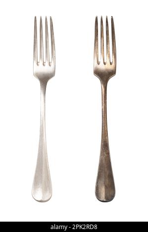 Polished and tarnished sterling silver fork handles, old and often used. Hydrogen sulfide and oxygen in the air react with layers of the metal. Stock Photo