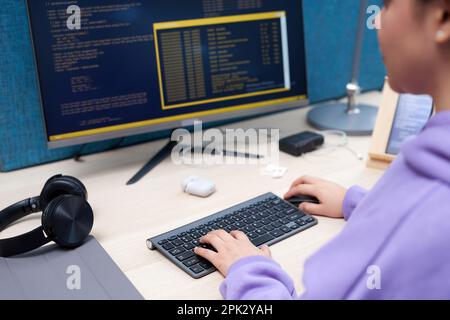 Close up of female ITprofessional writing code while working at office workplace Stock Photo