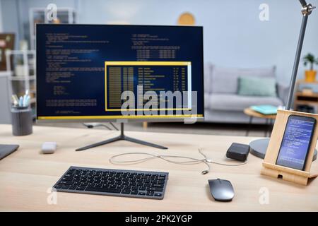 Close up of smartphone with code lines on IT developers workplace, copy space Stock Photo