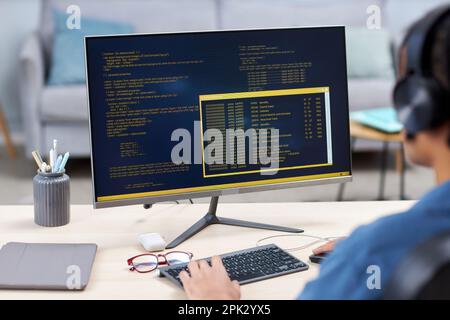Background image of computer screen with code lines and unrecognizable IT programmer working, copy space Stock Photo