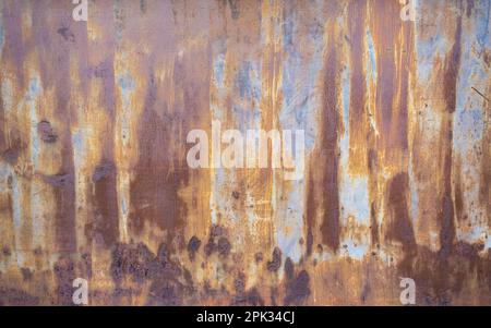 Close up of rusting steal metal sheet, with orange, yellow and blue colours Stock Photo