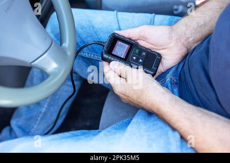 Using a car scan tool for repair diagnostics and check engine Stock Photo