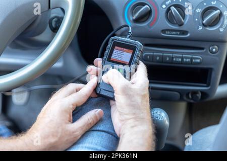 Using a car scan tool for repair diagnostics and check engine Stock Photo